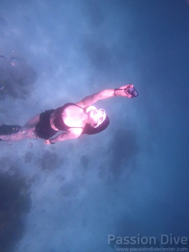 A freediver just below the surface immediately after entry at the Passion Dive housereef in Cebu