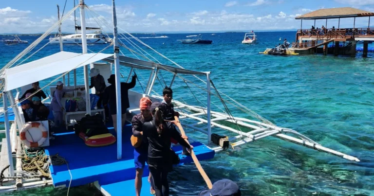 Guests boarding a private banca from the Passion Dive shop in Mactan, Cebu for an island hopping tour