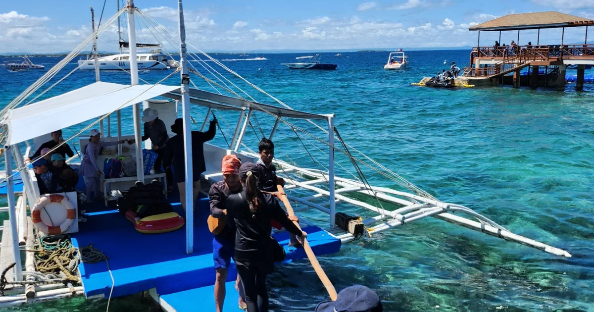 Guests boarding a private banca from the Passion Dive shop in Mactan, Cebu for an island hopping tour